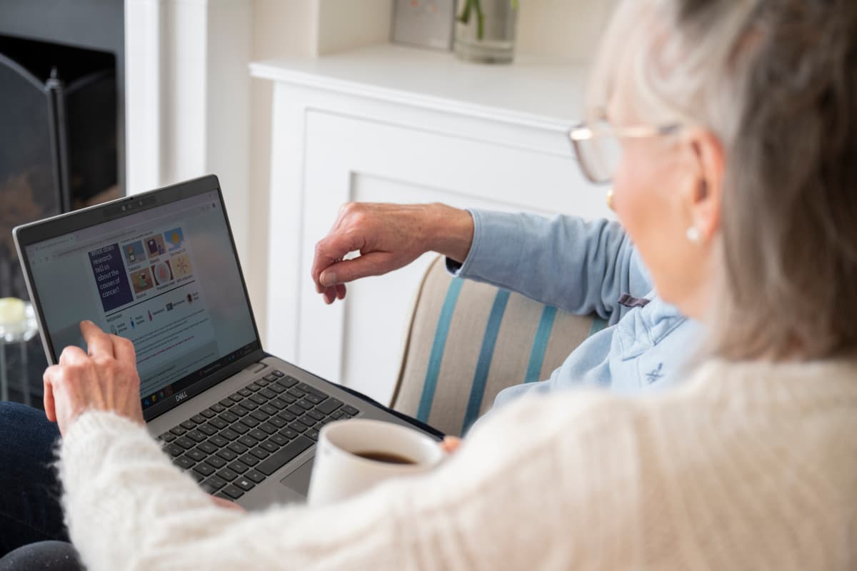 Adults pointing at a laptop.