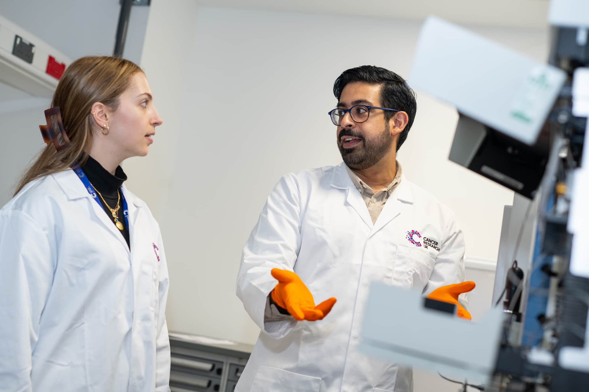 Two researchers looking at screen.