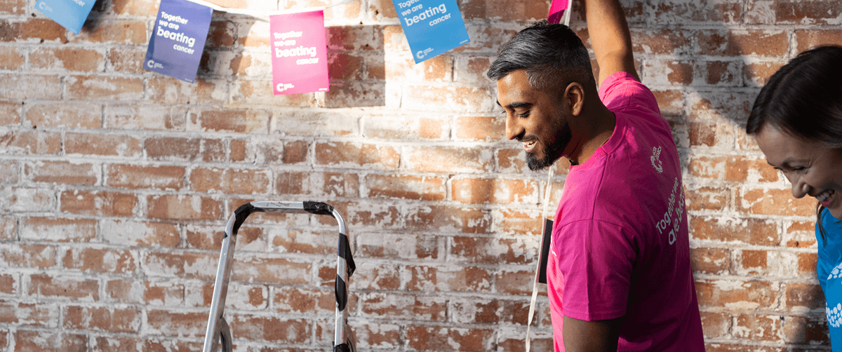 A photo of a Cancer Research UK volunteer at a fundraising event.