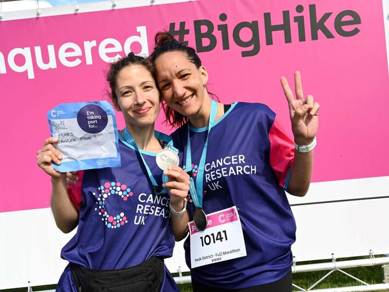 2 women posing with their Big Hike medals