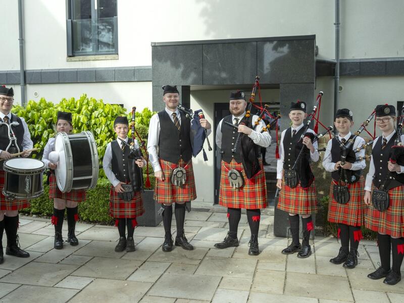 Scottish pipe band in traditional attire outdoors