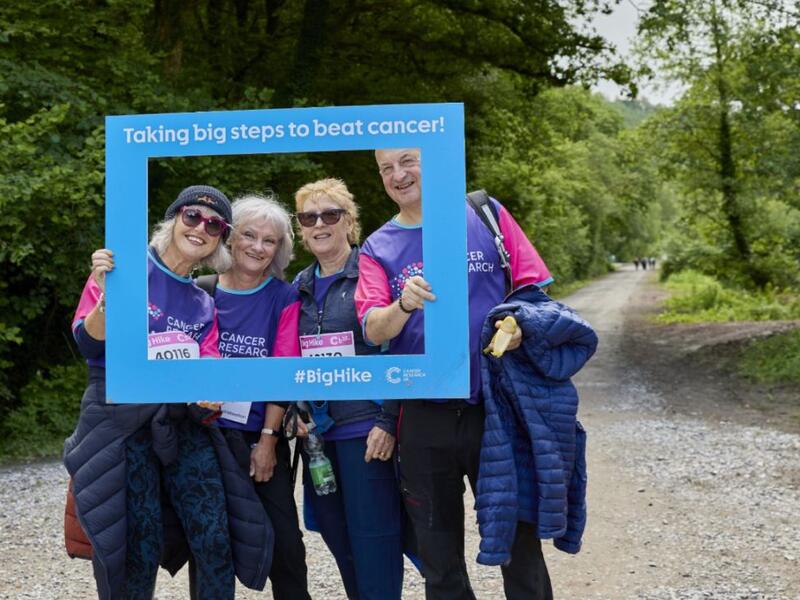 hikers posing in a Cancer Research UK frame