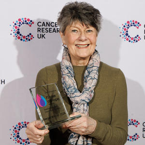 Ann holding her Flame of Hope trophy