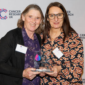 Ann holding her Flame of Hope trophy and guest