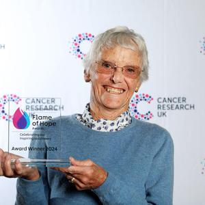 Audrey holding her Flame of Hope trophy