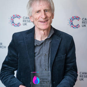 Christopher holding his Flame of Hope trophy