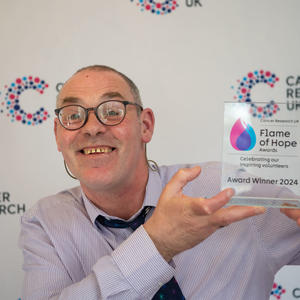 Craig holding his Flame of Hope trophy