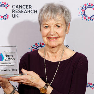 Diana holding her Flame of Hope trophy