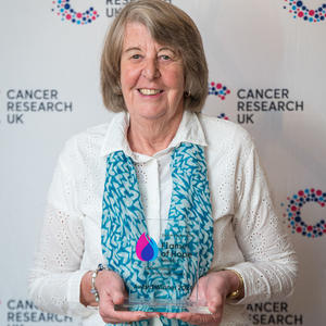 Eileen holding her Flame of Hope trophy