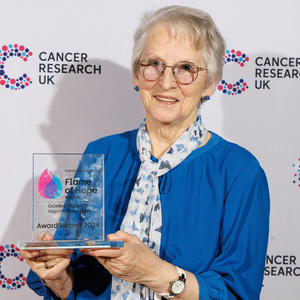 Elizabeth holding her Flame of Hope trophy