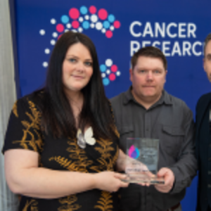 Felicity & Simon holding their Flame of Hope trophy