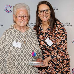 Joan holding her Flame of Hope trophy