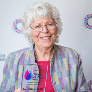 Joy holding her Flame of Hope trophy