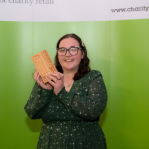 Lottie holding her Charity Retail Award