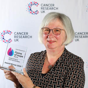 Mandy holding her Flame of Hope trophy