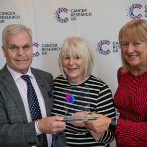 3 members of the Newark Committee holding their Flame of Hope trophy