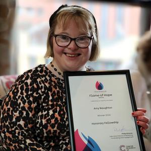 Amy holding her Flame of Hope certificate