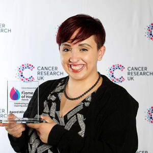 Rhian holding her Flame of Hope trophy