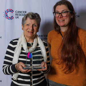 Ruth holding her Flame of Hope trophy and guest