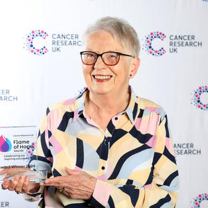 Sandra holding her Flame of Hope trophy