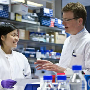 Two scientists chatting in a lab