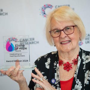 Sue holding her Flame of Hope trophy