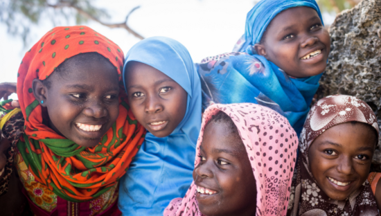 Young women smiling and looking at each other