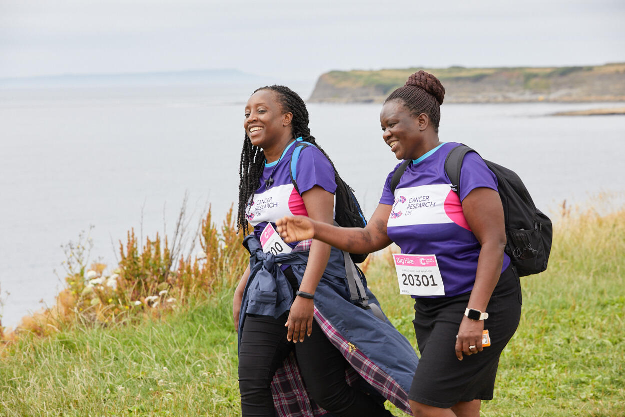 2 women walking along a coastal path