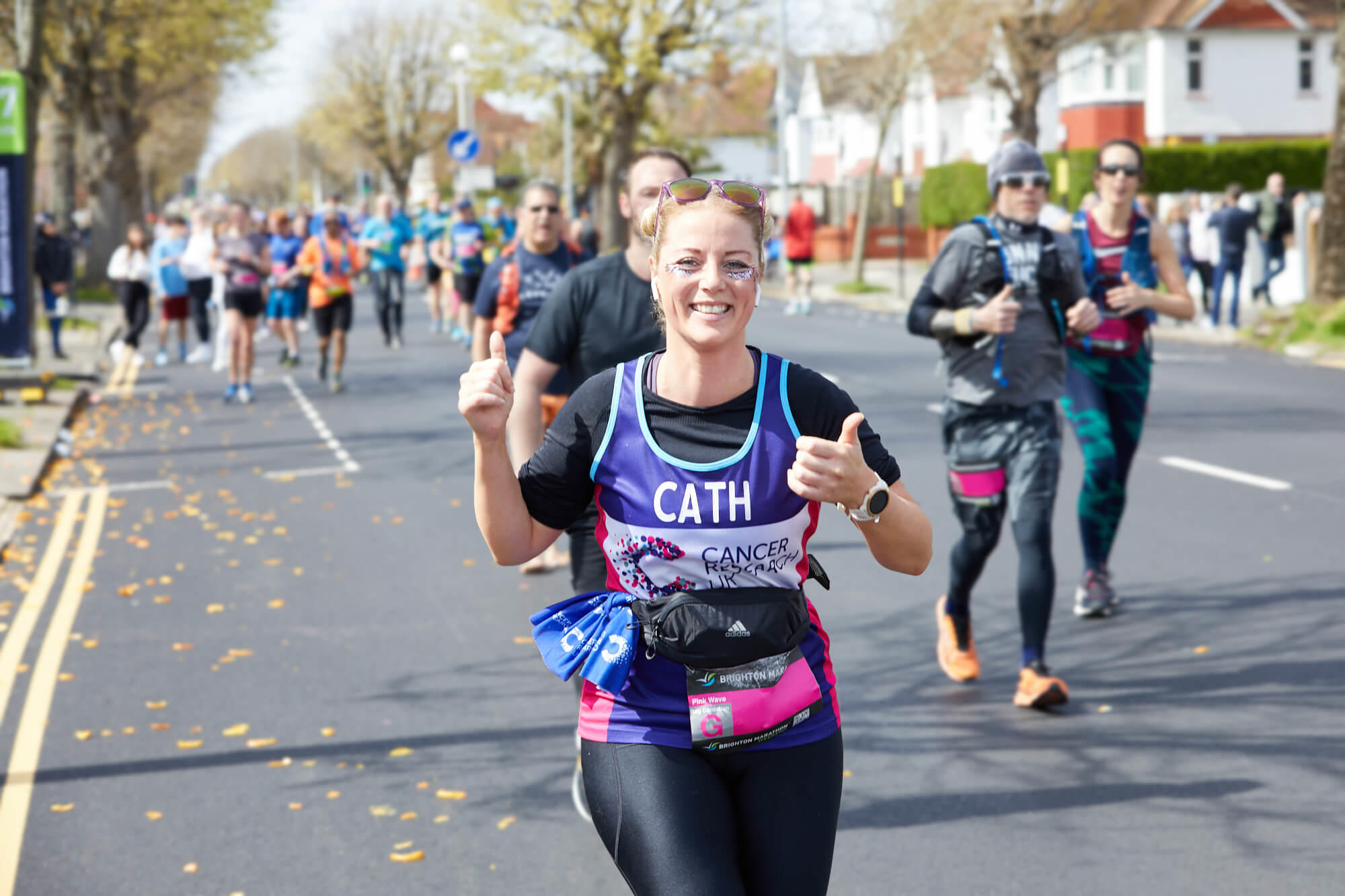 Run the race with Cancer Research Smiling woman running for Cancer Research UK