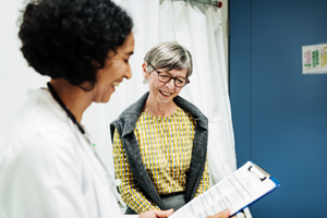 Image of a health professional and a patient looking at a tablet