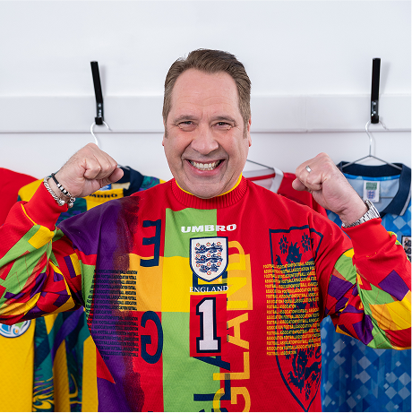 Image of David Seaman wearing a football shirt and cheering
