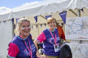 2 women smiling with Big Hike medals