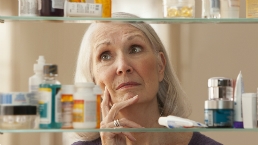 Woman examines cosmetics and toiletries