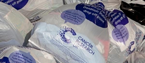 Pile of CRUK bags at a donation station 