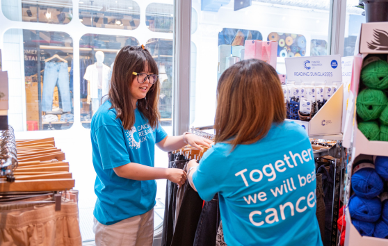 Two women volunteering in a shop