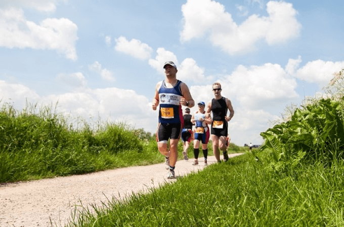 Men running the outlaw half Holkham in the sun