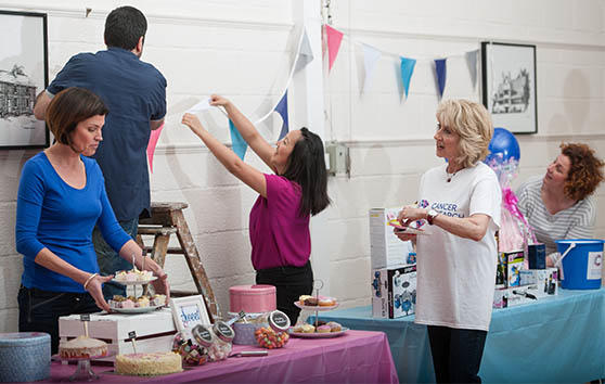 Photo of a fundraising group preparing for a bake sale