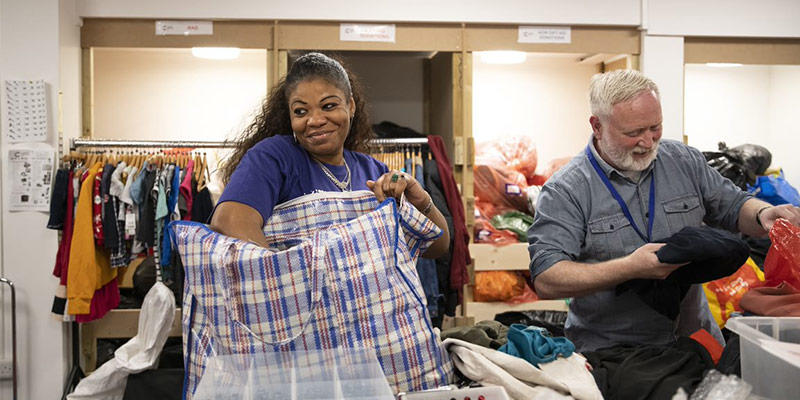 Photo of volunteers help unpack donated items