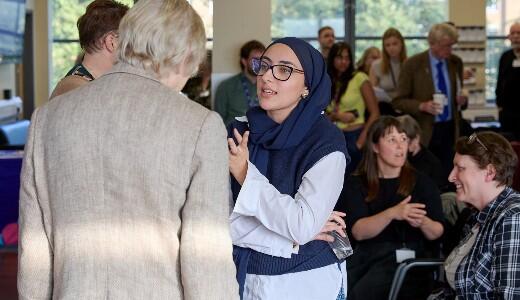 professor talking to attendee