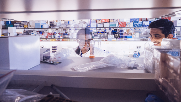 Two researchers chatting in the lab.