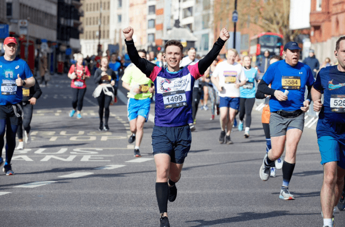 man running with his arms in the air