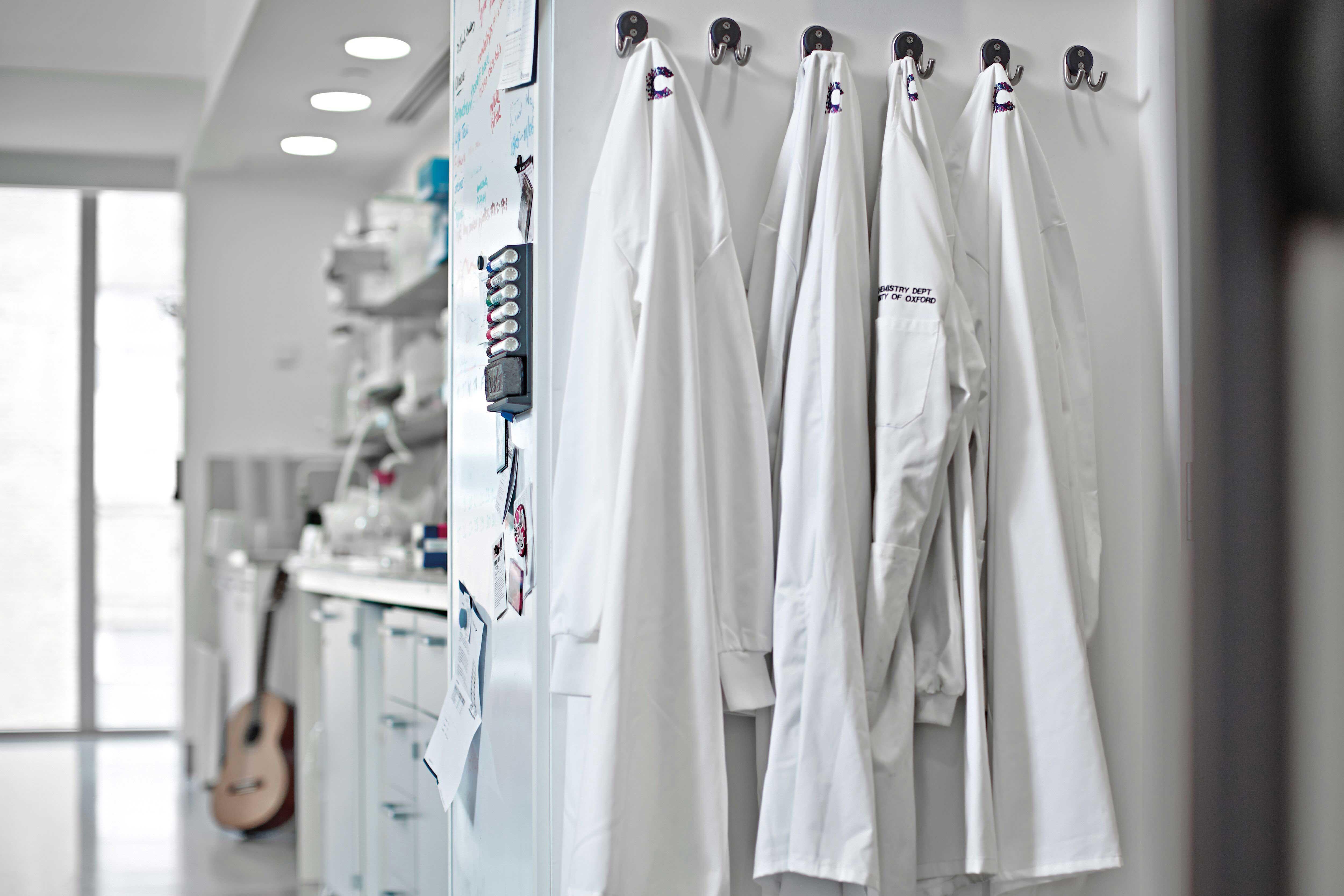 Lab coats hung up on coat hooks in a lab in Oxford