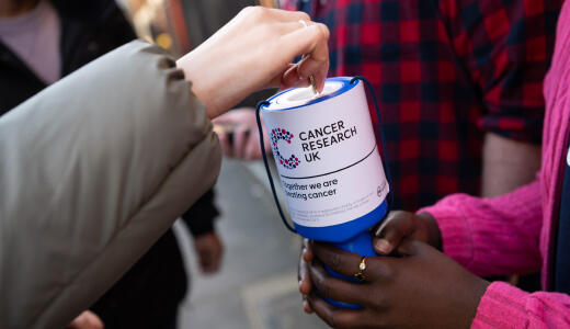 A photo of a Cancer Research UK donations pot