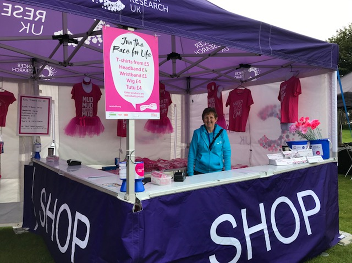 Photo of a smiling CRUK fundraiser running at an event