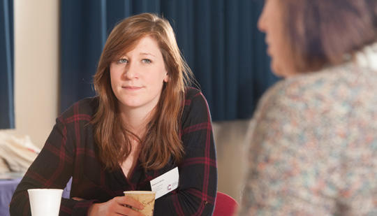 Two women sitting down chatting