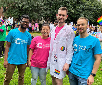 A photo of a group of people wearing CRUK t-shirts and looking happy at Manchester Pride 2023 