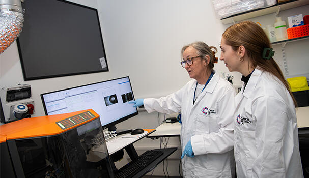 Two researchers in a lab looking at a computer screen