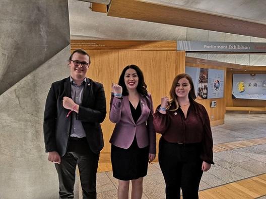 3 people uniting at Holyrood for World Cancer Day