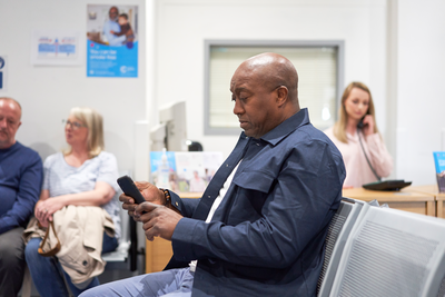 A photo of a man looking at his phone