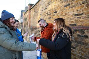 A photo of two CRUK volunteers collecting funds